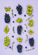 Fresh green and black grapes with thyme sprigs
