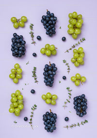 Fresh green and black grapes with thyme sprigs