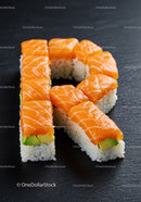 Fresh salmon sushi shaped like the letter R on black slate