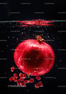 Fresh pomegranate submerged in sparkling water drops
