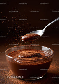 Velvety chocolate sauce with cocoa dust in glass bowl