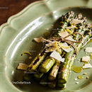 Grilled asparagus tied with twine and topped with parmesan
