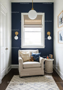 Modern Cozy Relaxation Corner with Navy Blue Accent Wall and Armchair