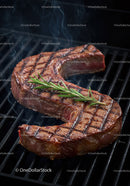 Grilled Ribeye Steak with Fresh Rosemary on Charcoal Grill