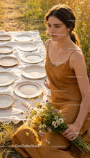 Young woman in brown dress holding wildflowers outdoors