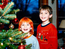Two happy boys enjoying Christmas tree decorating
