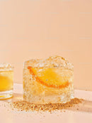 Close up of citrus slice frozen in clear ice cube