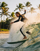 Focused Female Surfer Riding Ocean Wave at Sunset