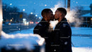 Two Men Sharing a Kiss on a Snowy Winter Night