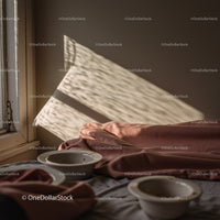 Sunlit Cozy Interior with Soft Textiles and Tableware in Warm Colors