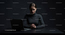 Thoughtful Woman at Laptop in Dark Modern Workspace
