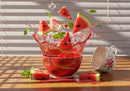 Watermelon slices splash with ice and fresh mint leaves