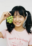 Happy Young Girl Holding Green Grapes with Big Smile