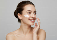 Smiling Woman Applying Facial Cream for Skincare Routine