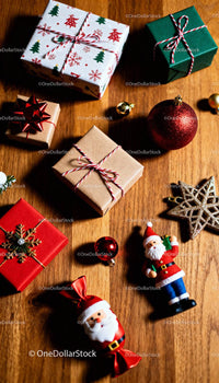 Christmas gifts and festive ornaments on wooden table