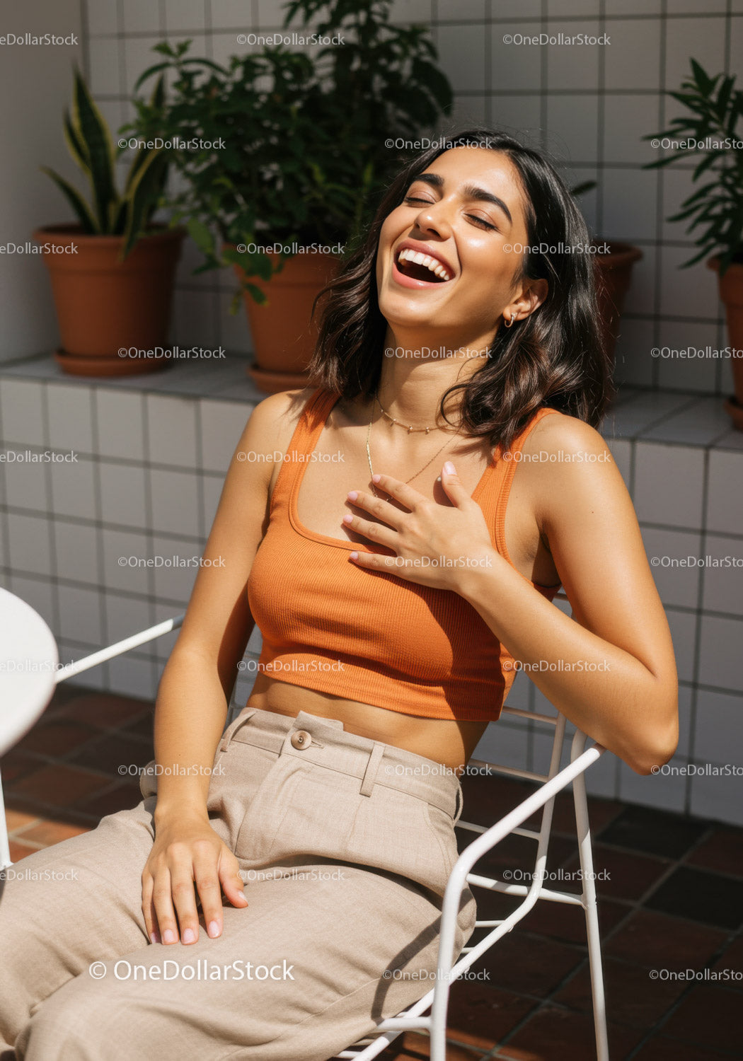 Joyful Woman Laughing in Bright Lounge with Potted Plants