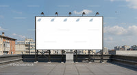 Large blank billboard on urban rooftop under blue sky