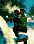 Couple Sharing a Tender Kiss on Snowy Winter Evening