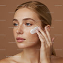 Close-Up of a Woman Applying Moisturizer on Her Face for Glowing Skin