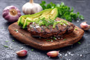 Juicy Grilled Steak with Avocado and Fresh Herbs on Wooden Board