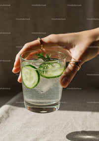 Hand Holding Refreshing Cucumber Sparkling Water Glass