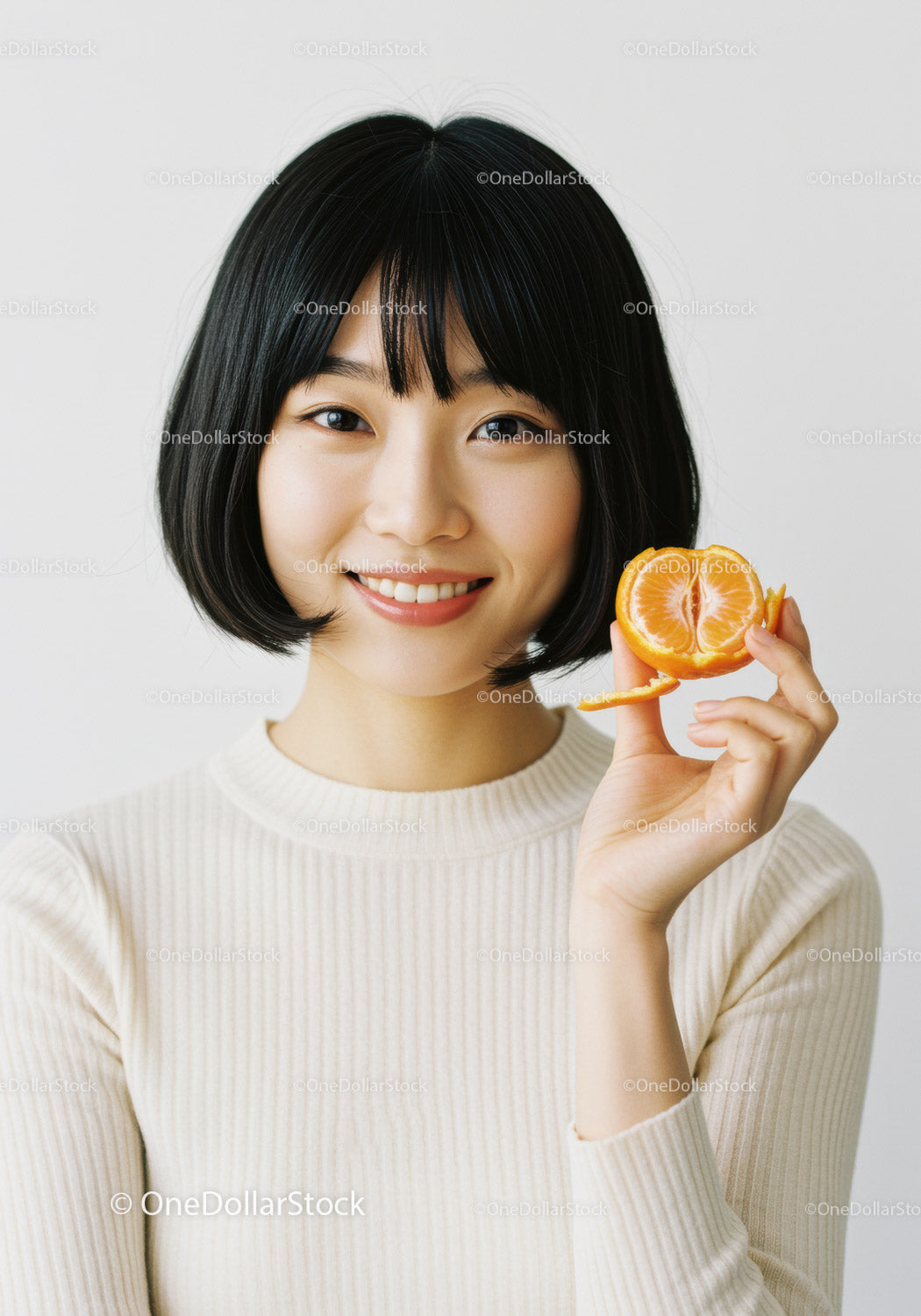 Young Asian Woman with Short Black Hair Holding Orange Citrus Fruit