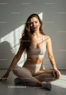 Calm young woman practicing yoga in natural light