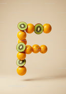 Letter F formed from fresh oranges and kiwi slices