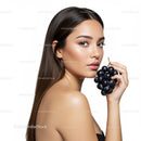 Elegant Young Woman with Dark Hair Holding Grapes for Health and Beauty