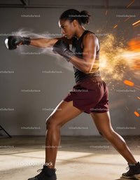 Focused female boxer delivering powerful punch in action
