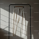 Minimalist white trousers hanging on black rack