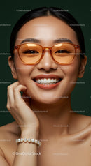 Smiling woman wearing stylish amber sunglasses and pearl bracelet