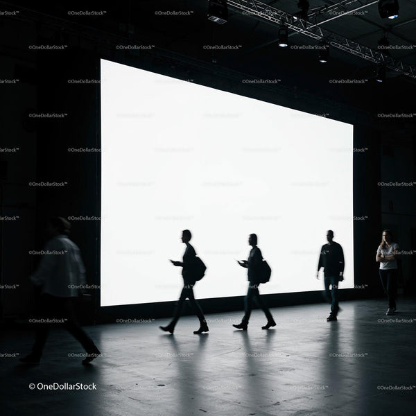 Silhouettes walking past large illuminated display screen JPG Mockup Image