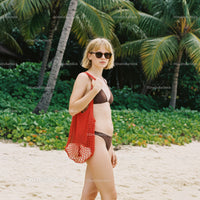 Woman in Bikini with Red Tote Bag on Tropical Beach with Palm Trees