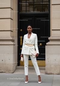 Confident woman in stylish white pantsuit with accessories