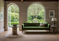 Minimalist living room with green velvet sofa and garden view