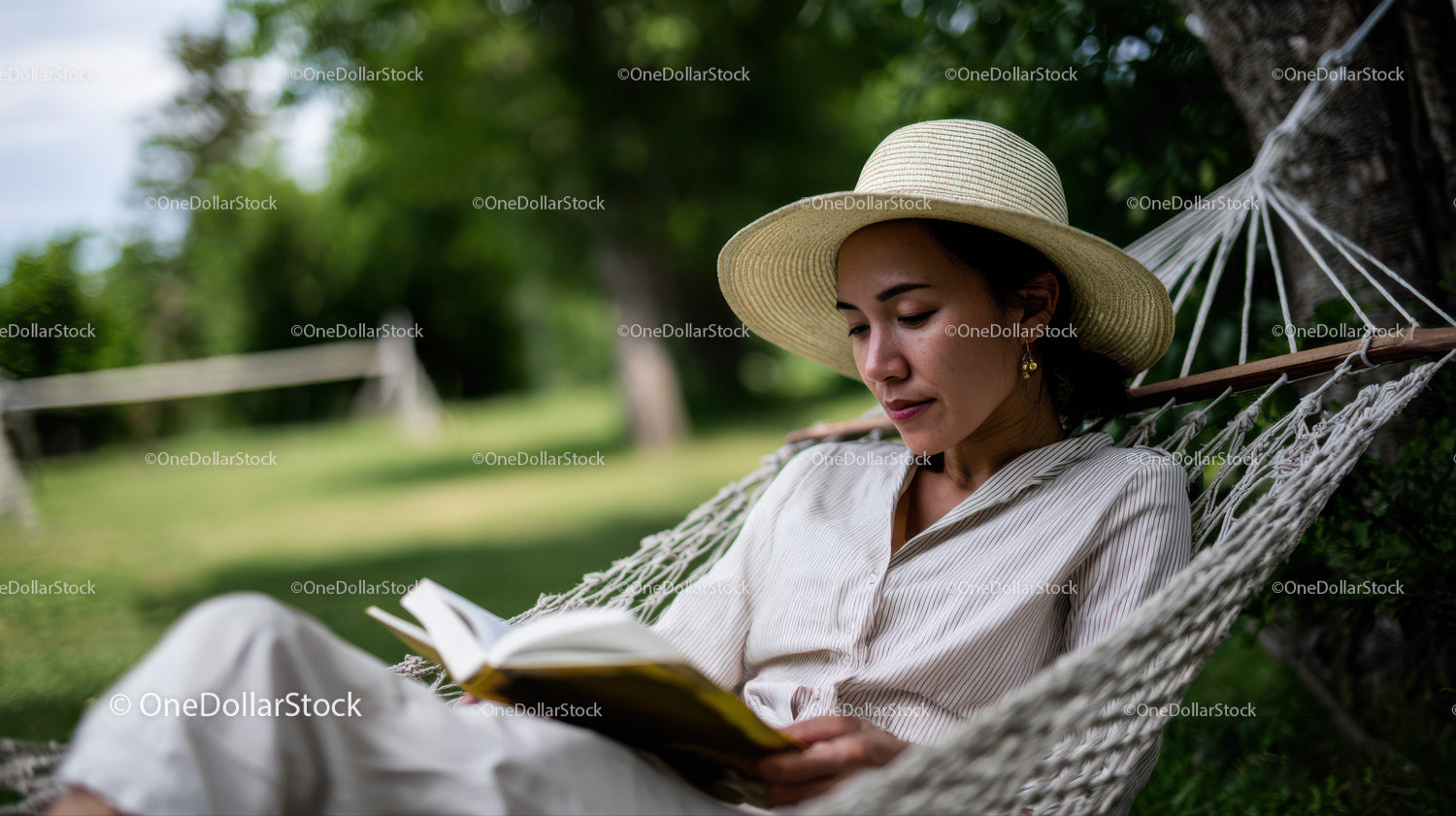 Woman Relaxing in Hammock Reading Book in Peaceful Garden