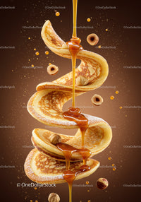 Golden pancakes with flowing caramel and hazelnuts