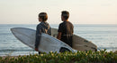 Two Surfers with Surfboards at Beach Ready for Waves