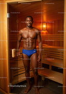 Man in Blue Swim Briefs Standing Inside Sauna Room for Wellness