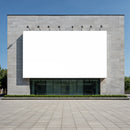 Modern building facade with blank white billboard outdoors