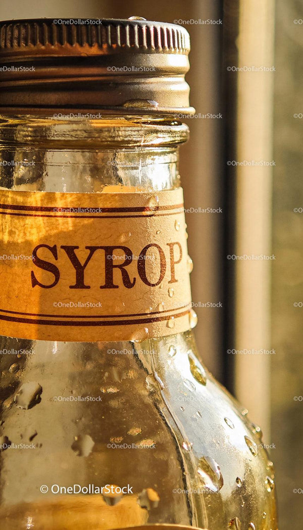 Close-Up of Syrup Bottle with Water Droplets