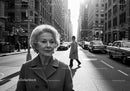 Elderly Woman in Busy City Street Surrounded by Vintage Cars