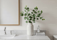Minimalist Bathroom with Green Eucalyptus in White Vase and Marble Surface