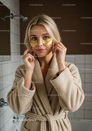 Young Woman Applying Under Eye Gel Patches in Spa Environment
