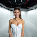 Smiling Woman in White Corset in Bright Studio Setting