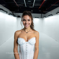 Smiling Woman in White Corset in Bright Studio Setting