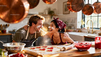 Couple Laughing While Baking Heart-Shaped Cookies Together