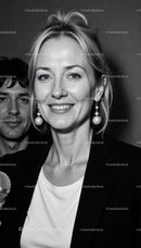 Confident Woman with Pearl Earrings Smiling in Black and White Portrait