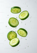 Fresh cucumber slices immersed in clear water droplets